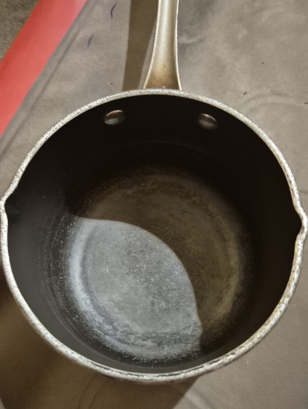 A Sauce Pan with a built in spouts on each side for pouring with vented cover.